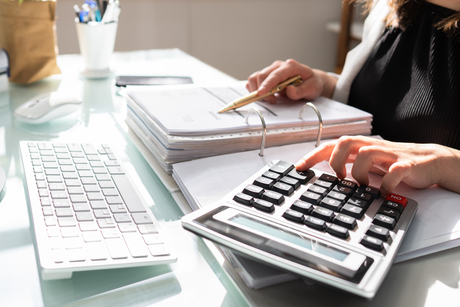 Hands, calculator and keyboard bookkeeping